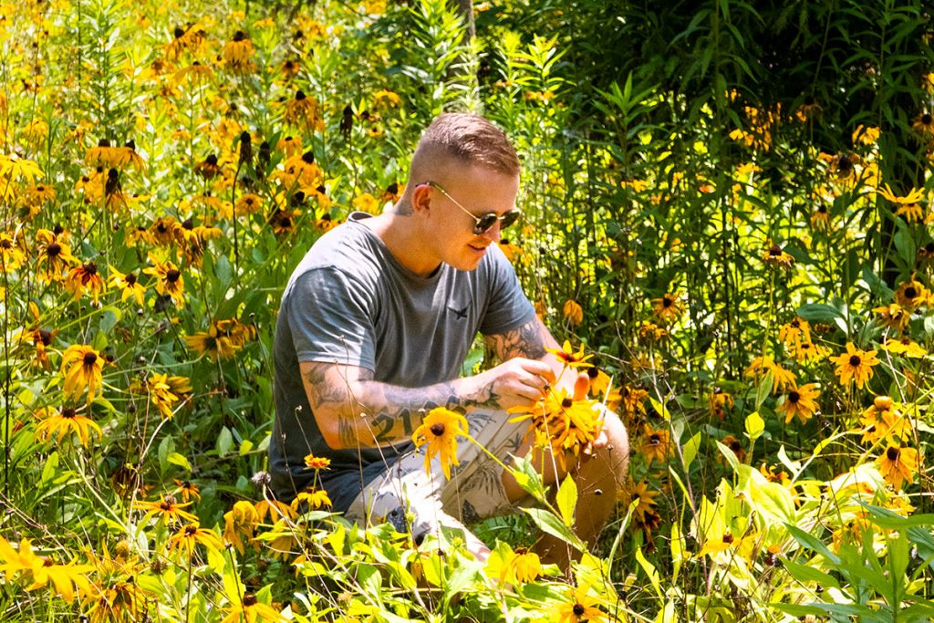 Chef/forager Elijah Holland picking echinacea at Gucun Park. Photo by Rachel Gouk